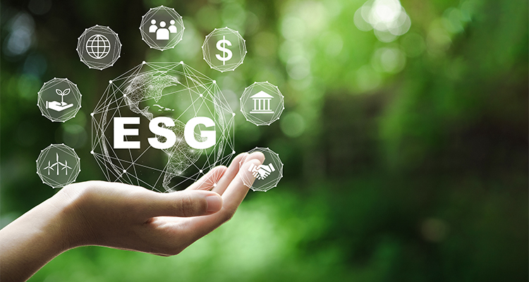 ESG concept in a hand against a green background