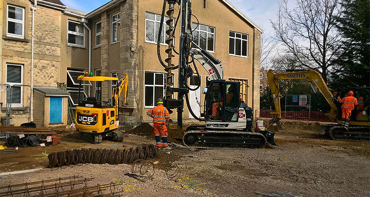 Drilling piling hole in residential construction site
