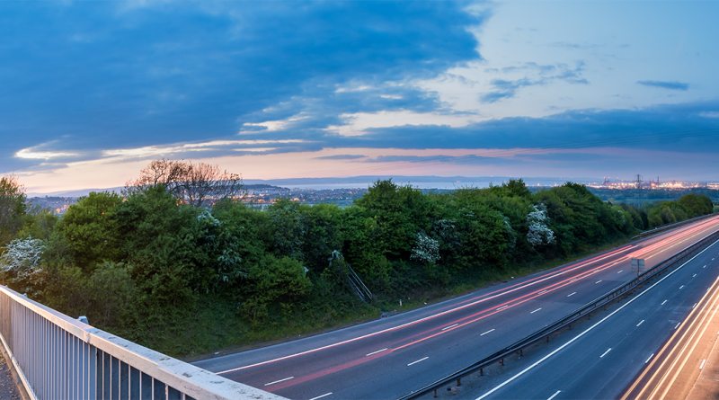 Panoramic image of a bridge going over a motorway in the UK to support Britain's infrastructure article