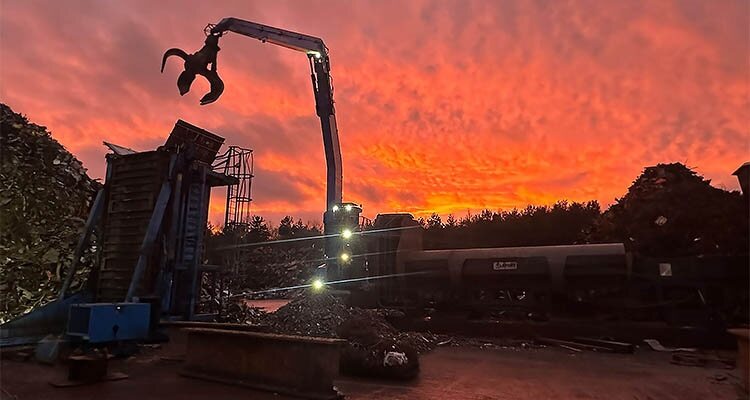 Recycling facility with crane in sunset