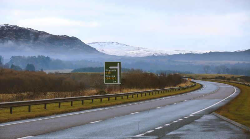 A stretch of the A9 road in Scotland with signs