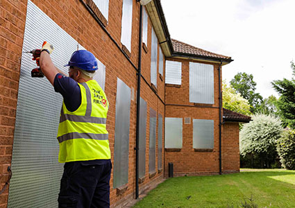 Worker installing Sitex Security Screen