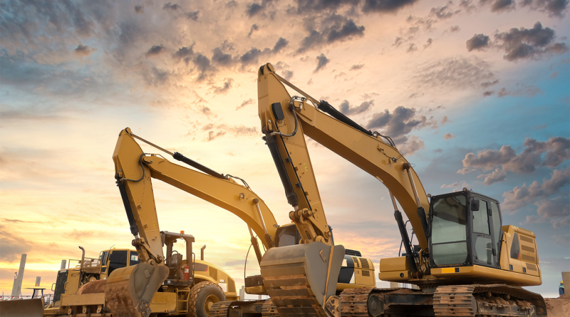 different construction equipment out in a yard