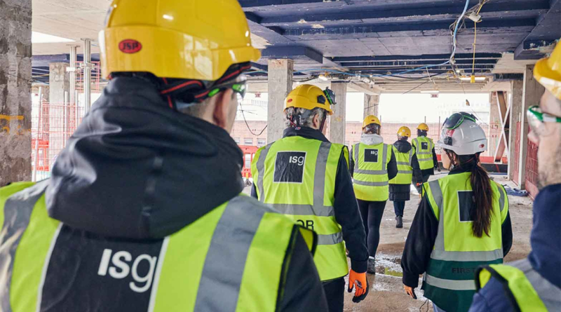 ISG construction workers walking through site to support article