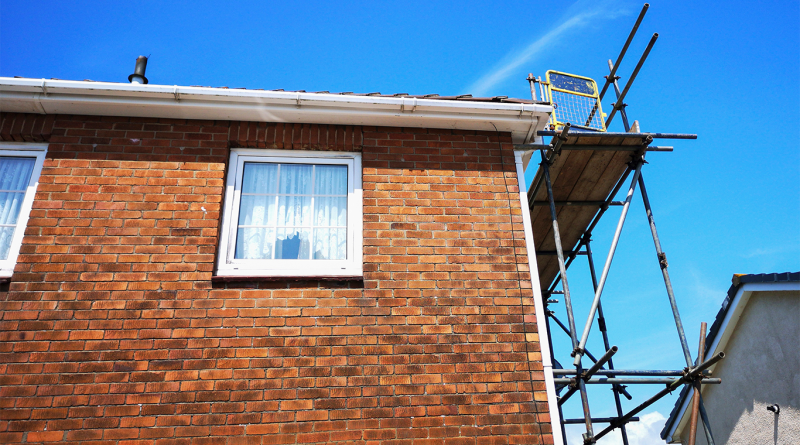 House with scaffolding on to support UK stalled housing projects article