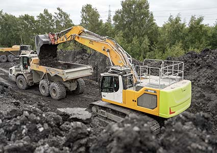 Earthmoving equipment filling a tipper truck