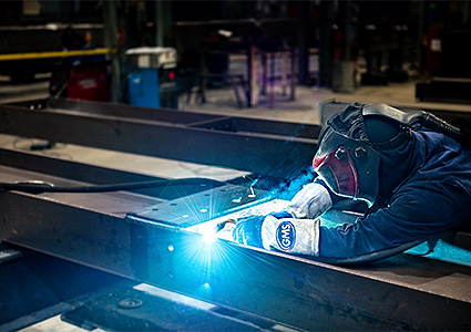 Worker welding a steel frame