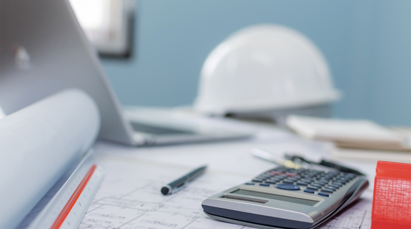 Construction hardhat on desk with papers and calculator to support ISG collapse article