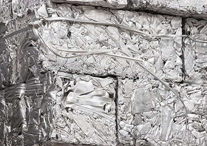 pressed aluminum scrap background and texture, silver metal recycling.