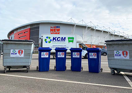 KCM Skips, Wheelie Bins & van in front of building