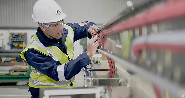 Woodward group technician working on some machinery