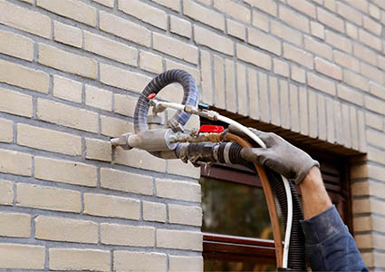 Cavity wall insulation being installed