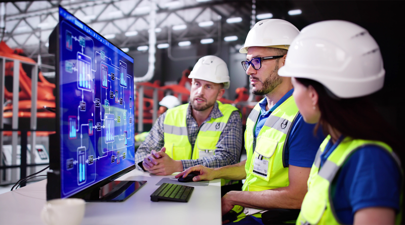 Construction workers gathered around computer to support AI Construction Training article