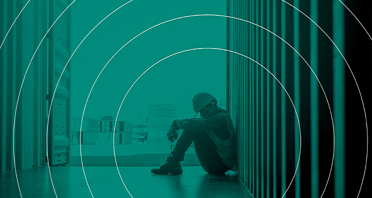 a person in a work setting who appears to be experiencing distress or contemplation