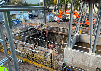 a construction site with a deep excavation for a basement or foundation