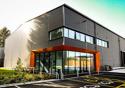 a modern industrial building that is part of the Trade City Manchester development on Elizabeth Street in Manchester