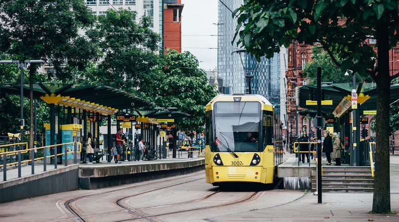 Metrolink tram travelling through MediaCity in Greater Manchester during network upgrade programme