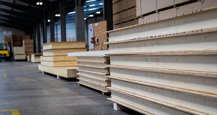 several large stacks of structural insulated panels