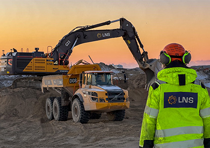 a Volvo A30G Articulated Hauler being loaded by an excavator at a construction site