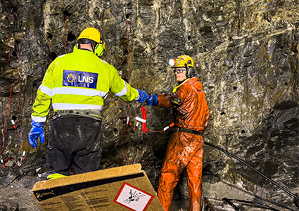two workers in an underground mining or tunnel construction