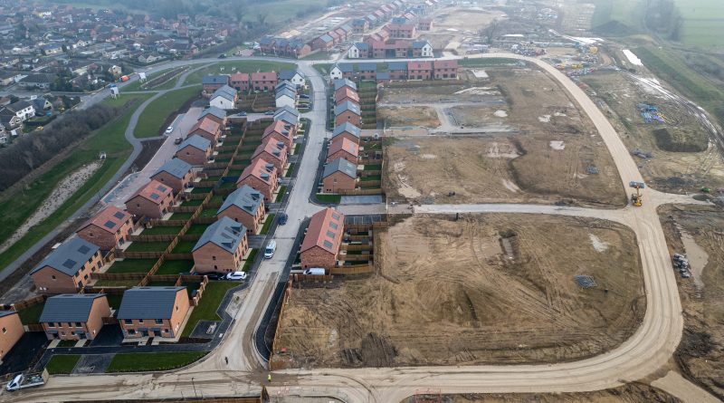 Newly built housing development in the UK symbolizing the affordability crisis.