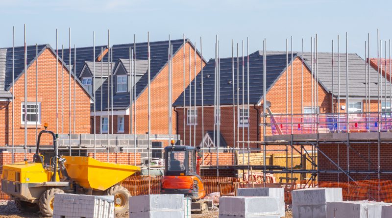 Construction workers on a UK commercial building site during early morning operations