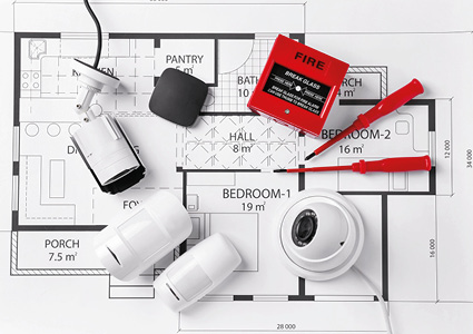an integrated home life safety and security hardware layout arranged over architectural blueprints