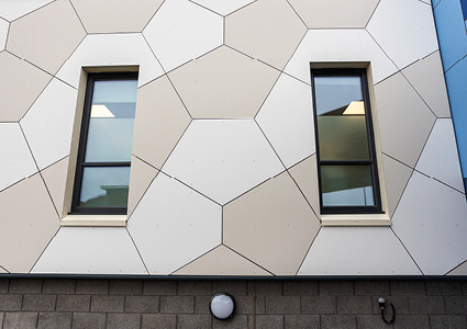 building facade features a geometric design, likely created with modular cladding panels like Equitone or Trespa