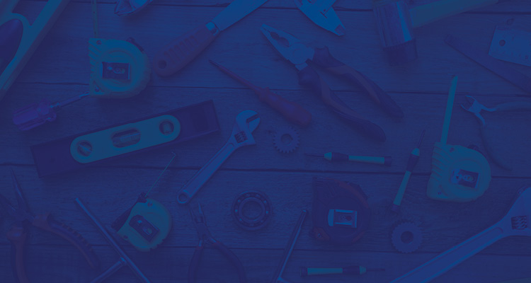 a collection of hand tools laid out on a flat wooden surface under a dark blue and purple color filter