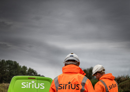 personnel wearing branded orange high-visibility jackets with a "Sirius" logo