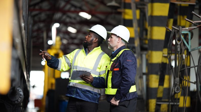 power equipment maintenance, repair and rental with two maintenance workers fixing a machine
