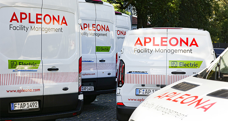 a fleet of white commercial vans parked close together