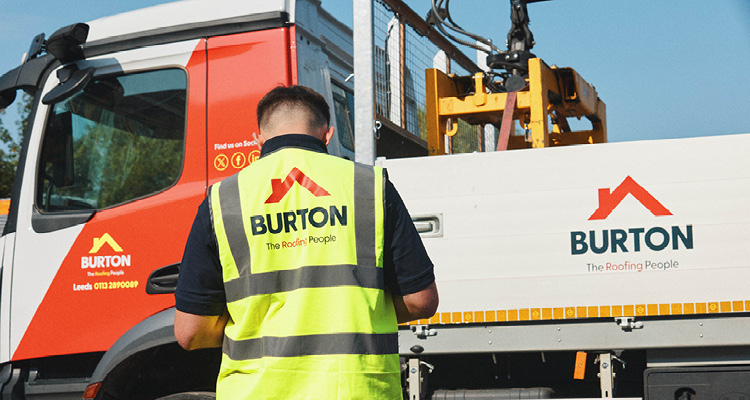 a worker and commercial vehicles belonging to Burton Roofing Merchants, trading under the slogan "The Roofing People".
