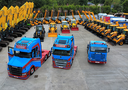 an aerial view of a commercial vehicle yard featuring a specialized fleet of heavy machinery and transport trucks belonging to C.J. Leonard & Sons LTD