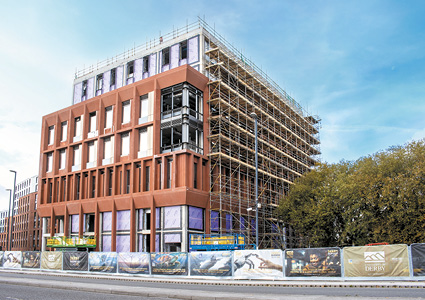 A multi-story modern building is being built.