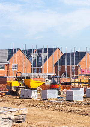 A yellow Thwaites site dumper is being used to move materials around the residential construction site