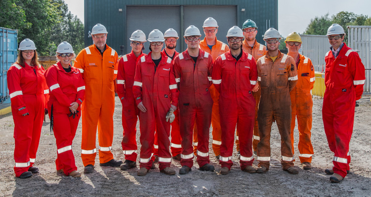 Serimax pipeline welding employees wearing branded red and orange fire-resistant overalls