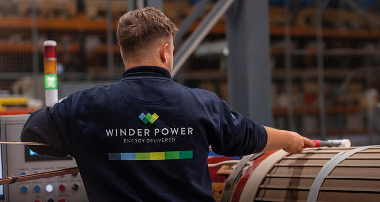 a factory worker inside an industrial manufacturing facility, photographed from behind