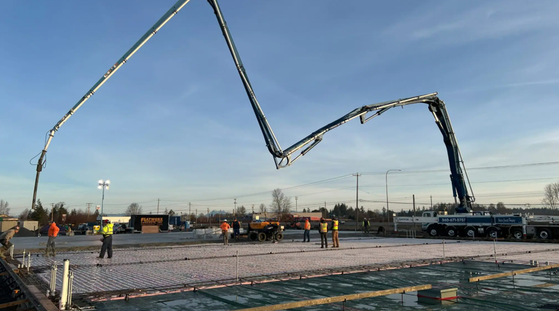 Concrete placement for Pape Kenworth's Ferndale, Washington facility using FORTA-FERRO synthetic fibers at 7.5 lb/cu yd to reduce traditional steel rebar requirements for heavy truck loads.