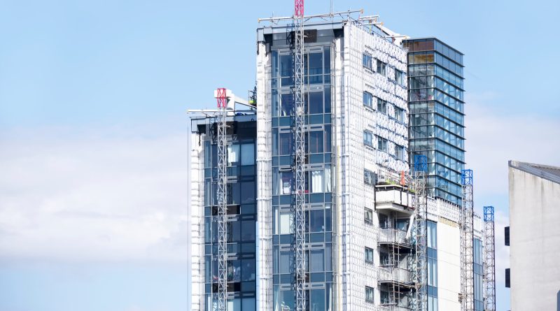 Residential buildings undergoing cladding remediation work in England