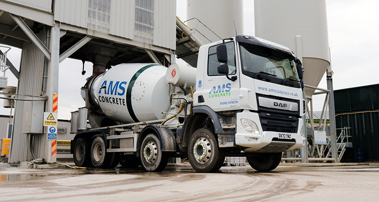 a white DAF concrete mixer truck branded with the logo of AMS Concrete