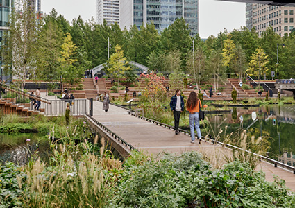 a vibrant, modern urban park that seamlessly blends lush green landscaping with contemporary architecture