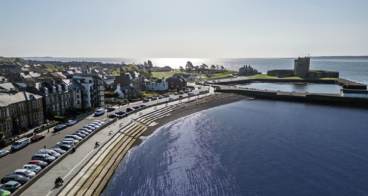 an aerial view of Broughty Ferry Beach and Broughty Castle on the River Tay in Dundee, Scotland