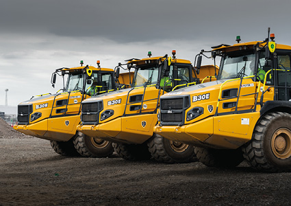  a line of Bell B30E Articulated Dump Trucks
