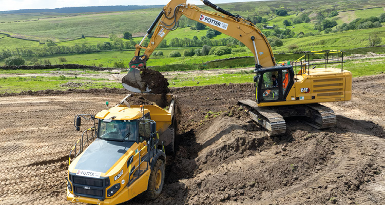 a yellow Caterpillar hydraulic crawler excavator loading soil into a Caterpillar articulated dump truck branded with Potter